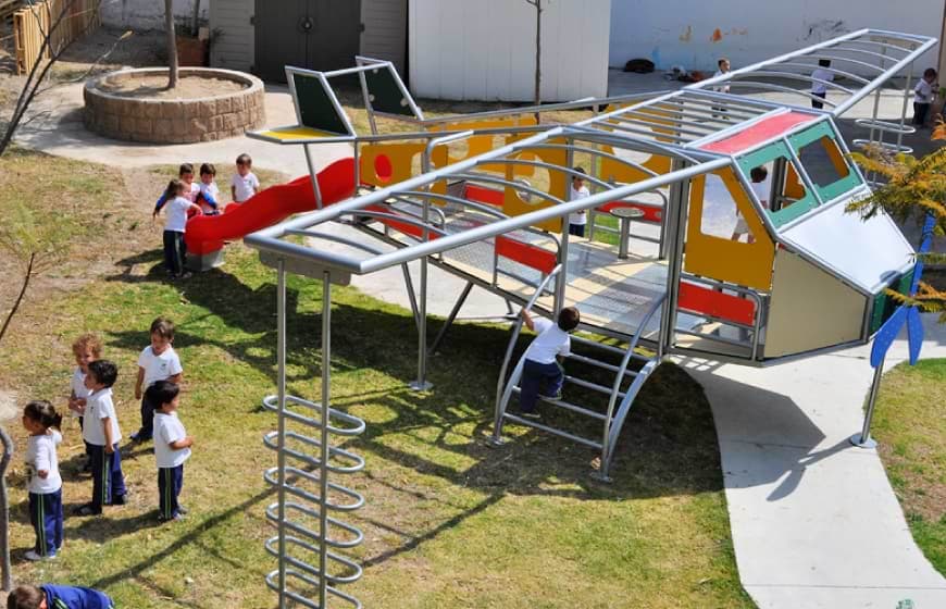 Juego infantil con forma de avión instalado en colegio